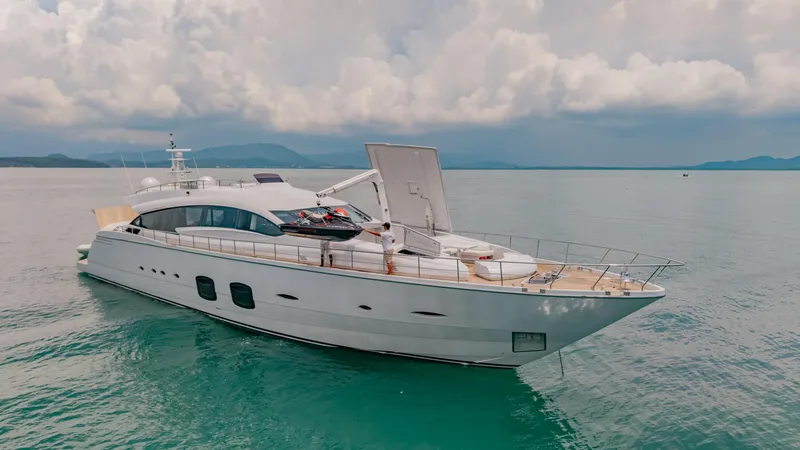 Le Caprice IV Yacht Photos Pics Luxurious 2011 Pershing 108 yacht on serene ocean waters under cloudy skies.