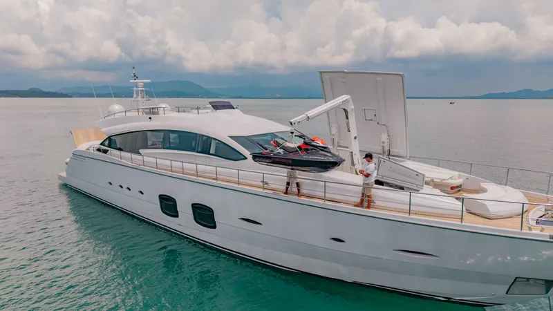 Le Caprice IV Yacht Photos Pics Luxurious 2011 Pershing 108 yacht with jet ski on deck, cruising in serene waters.