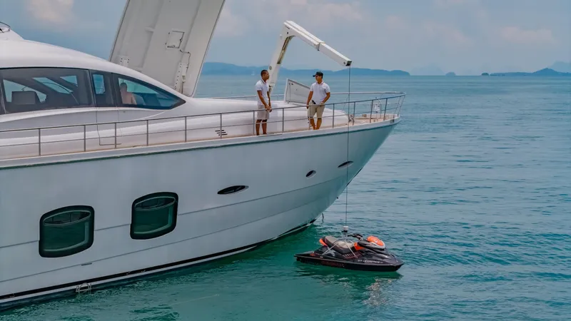 Le Caprice IV Yacht Photos Pics Luxury Pershing 108 yacht with jet ski, 2011 model, on calm blue sea.