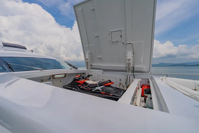 Le Caprice IV Yacht Photos Pics 2011 Pershing 108 yacht with open storage compartment, revealing a jet ski and equipment.