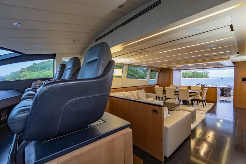 Le Caprice IV Yacht Photos Pics Luxurious interior of 2011 Pershing 108 yacht with elegant seating and scenic ocean view.