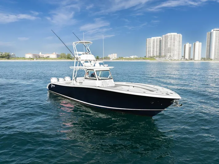  Yacht Photos Pics 2016 Yellowfin 42 boat on water with city skyline in background.