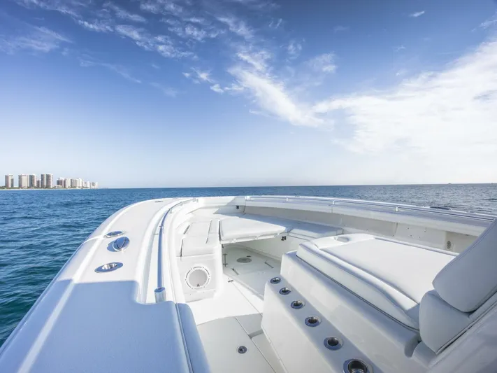  Yacht Photos Pics 2016 Yellowfin 42 boat on open sea with city skyline in background.