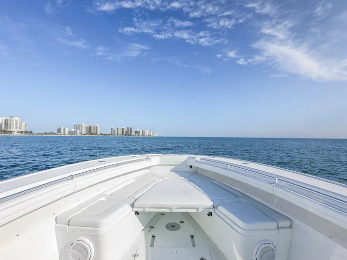  Yacht Photos Pics 2016 Yellowfin 42 boat on open sea with city skyline in background.
