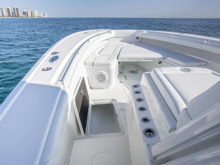  Yacht Photos Pics 2016 Yellowfin 42 boat interior with seating, ocean view, and city skyline in background.