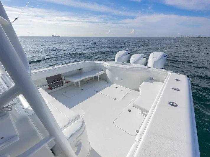  Yacht Photos Pics 2016 Yellowfin 42 boat deck with triple outboard motors on open sea.