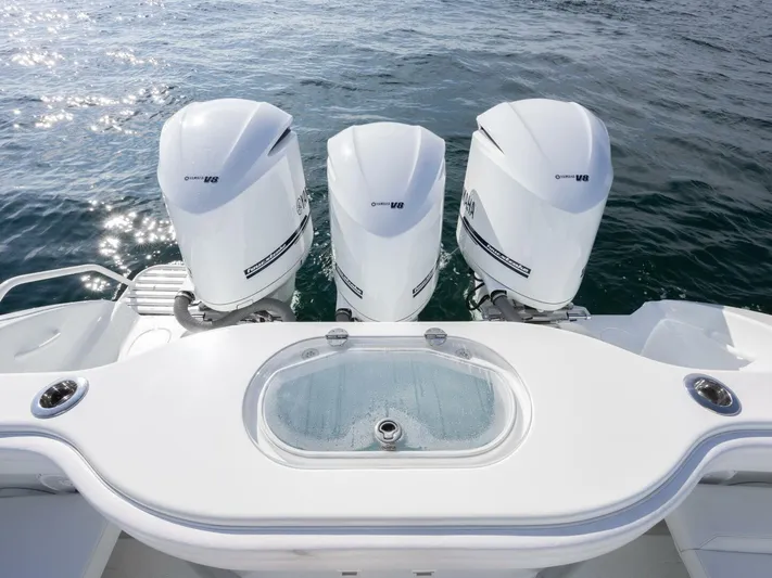  Yacht Photos Pics 2016 Yellowfin 42 boat with triple outboard engines on open water.