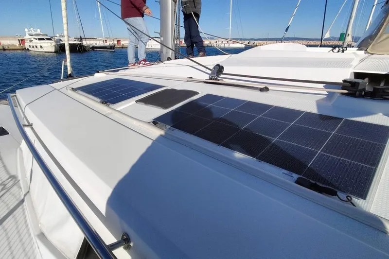  Yacht Photos Pics 2021 Fountaine Pajot Saona 47 catamaran with solar panels on deck, docked at marina.