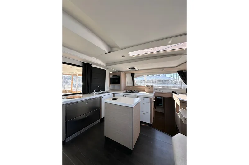  Yacht Photos Pics Modern kitchen interior of 2021 Fountaine Pajot Saona 47 catamaran with sleek design and ample lighting.