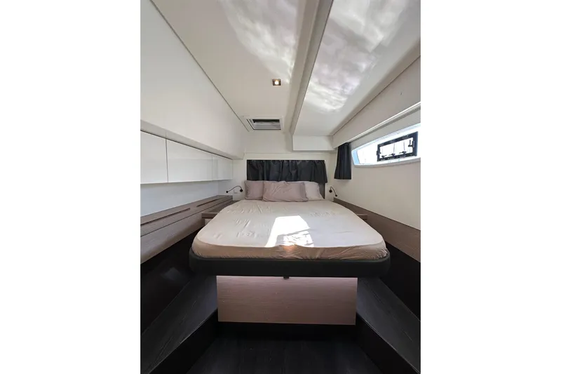  Yacht Photos Pics Interior cabin of 2021 Fountaine Pajot Saona 47 catamaran, featuring a cozy bed and modern design.