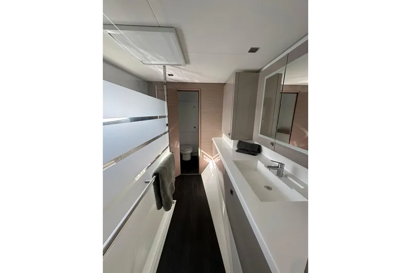  Yacht Photos Pics Modern bathroom interior of 2021 Fountaine Pajot Saona 47 yacht, featuring sleek design and fixtures.