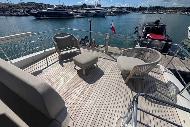  Yacht Photos Pics Luxurious deck of 2023 Absolute 60 Fly yacht with elegant seating and marina view.