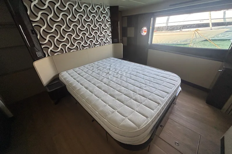  Yacht Photos Pics Luxurious bedroom interior of 2023 Absolute 60 Fly yacht with modern design and large window view.
