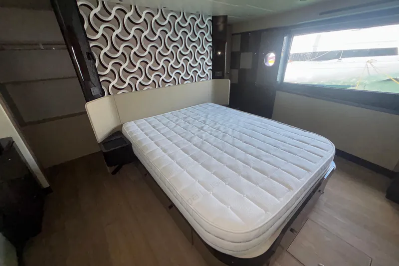  Yacht Photos Pics Luxurious bedroom interior of 2023 Absolute 60 Fly yacht with modern design elements.