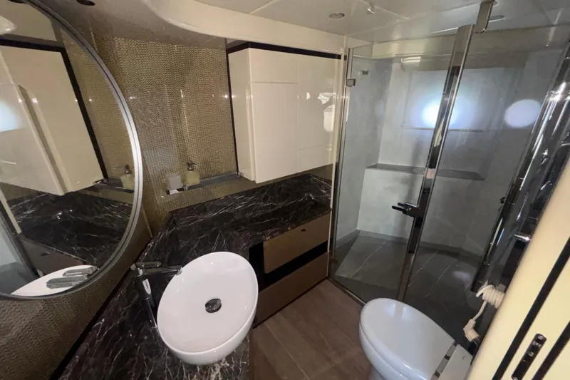  Yacht Photos Pics Luxurious bathroom in 2023 Absolute 60 Fly yacht with modern fixtures and marble countertop.
