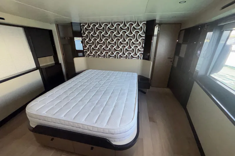  Yacht Photos Pics Luxurious bedroom interior of 2023 Absolute 60 Fly yacht with modern design elements.