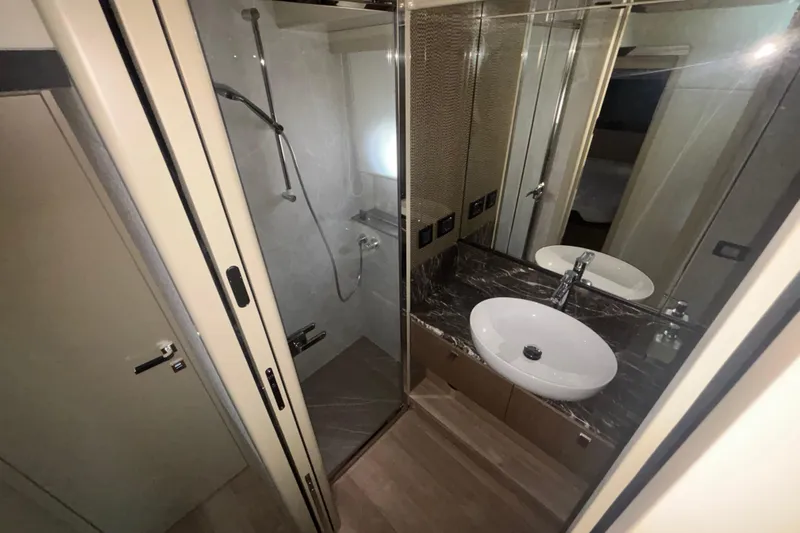  Yacht Photos Pics Luxurious bathroom in 2023 Absolute 60 Fly yacht with modern fixtures and elegant design.