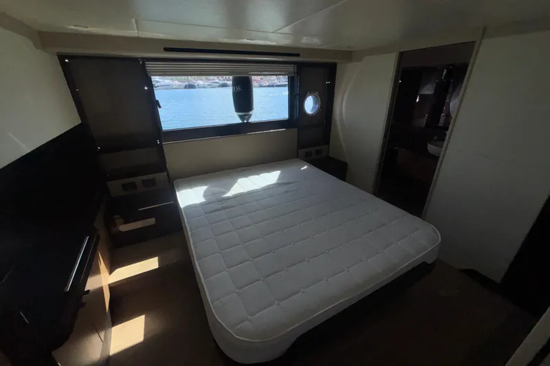  Yacht Photos Pics Luxurious bedroom interior of 2023 Absolute 60 Fly yacht with sea view window.