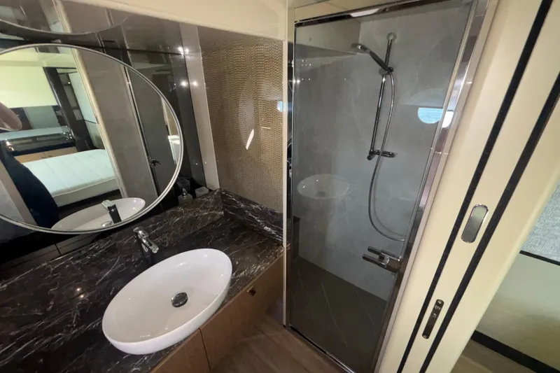  Yacht Photos Pics Luxurious bathroom in 2023 Absolute 60 Fly yacht with modern shower and elegant sink.