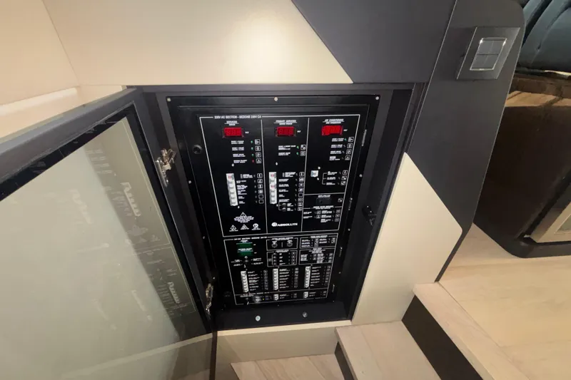  Yacht Photos Pics Electrical panel inside 2023 Absolute 60 Fly yacht, showcasing control systems and switches.