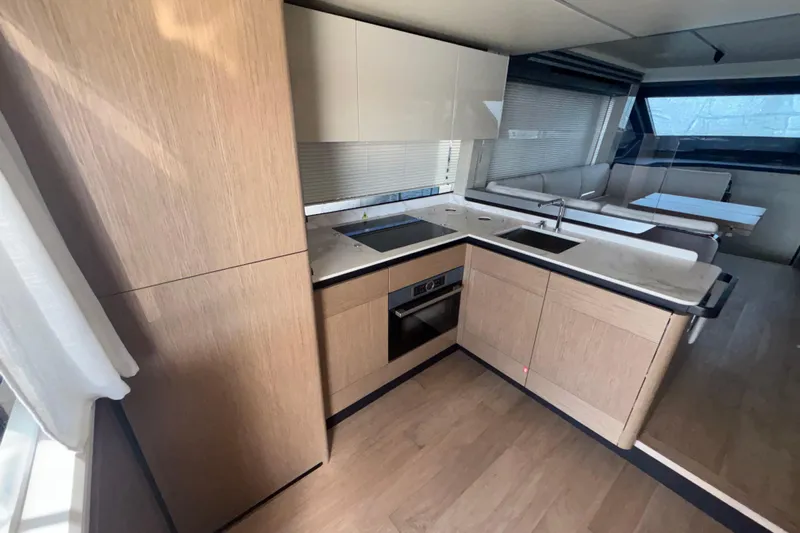  Yacht Photos Pics Modern kitchen interior on 2023 Absolute 60 Fly yacht, featuring sleek cabinetry and appliances.