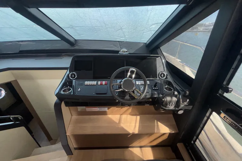  Yacht Photos Pics 2023 Absolute 60 Fly yacht helm with modern controls and panoramic windows.