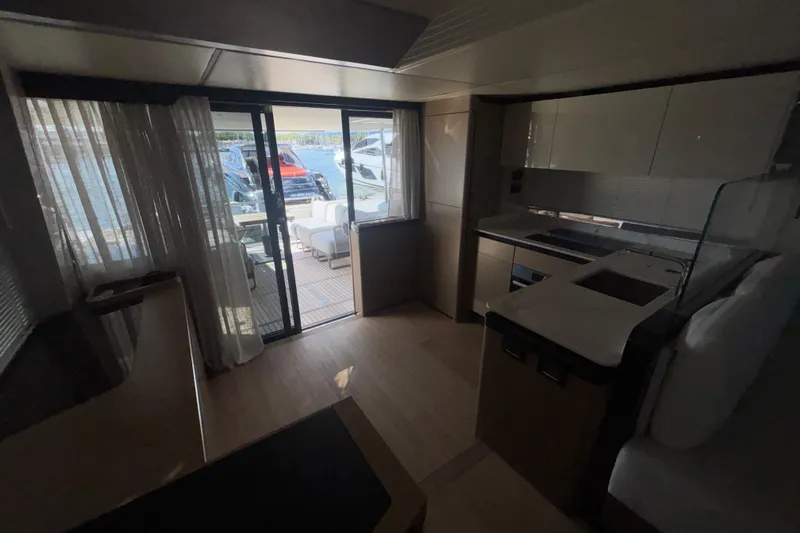  Yacht Photos Pics Luxurious interior of 2023 Absolute 60 Fly yacht with modern kitchen and deck view.