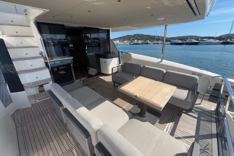 Yacht Photos Pics Luxurious 2023 Absolute 60 Fly yacht deck with elegant seating and scenic marina view.