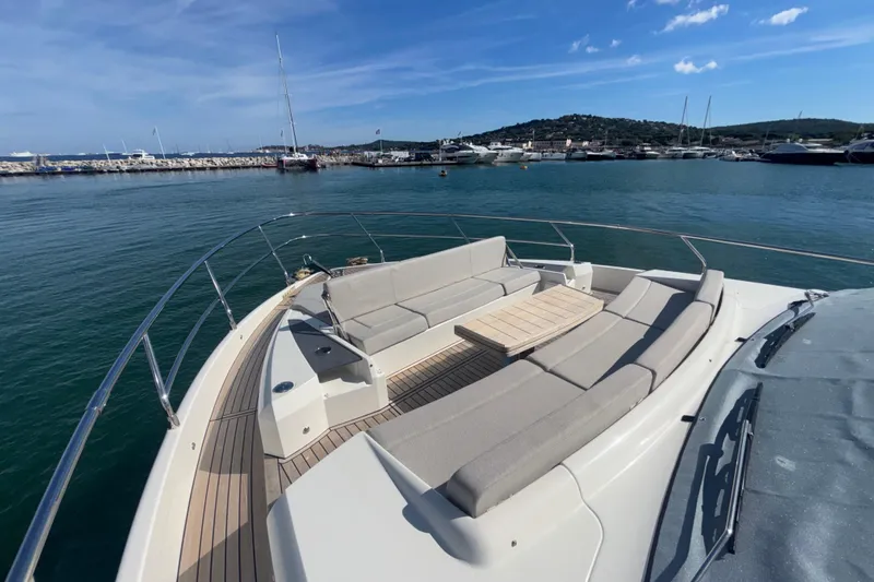  Yacht Photos Pics Luxurious 2023 Absolute 60 Fly yacht with spacious deck seating and scenic marina view.