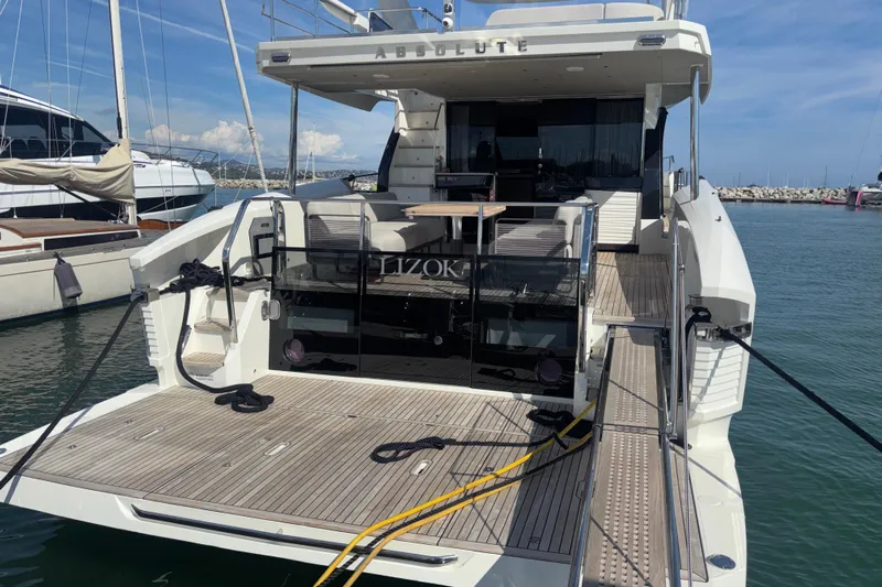  Yacht Photos Pics Luxury 2023 Absolute 60 Fly yacht docked at marina, showcasing elegant design.