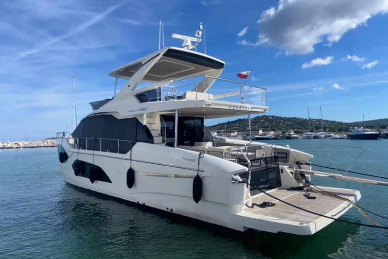 Yacht Photos Pics 2023 Absolute 60 Fly yacht docked in a marina under a clear blue sky.