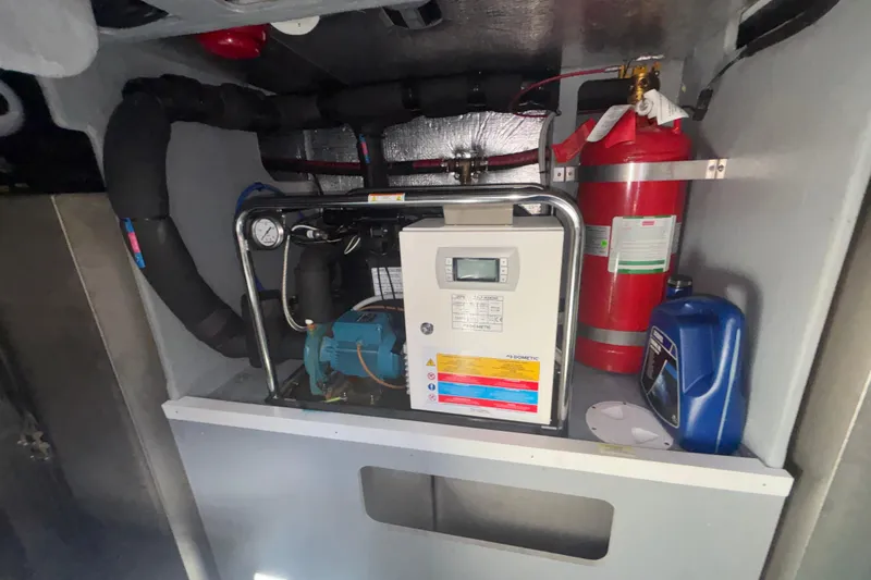  Yacht Photos Pics Engine room of 2023 Absolute 60 Fly yacht with equipment and fire extinguisher.