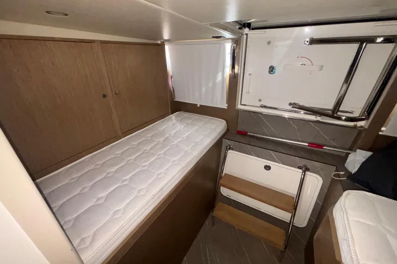  Yacht Photos Pics 2023 Absolute 60 Fly yacht interior with a compact cabin and wooden accents.