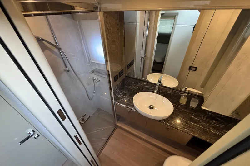 Lizok Yacht Photos Pics Luxurious bathroom in 2023 Absolute 60 Fly yacht with modern fixtures and marble countertop.