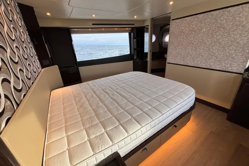 Lizok Yacht Photos Pics Luxurious bedroom interior of 2023 Absolute 60 Fly yacht with ocean view.