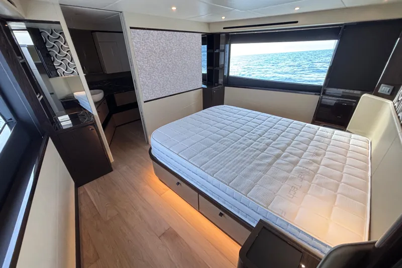 Lizok Yacht Photos Pics Luxurious bedroom interior of 2023 Absolute 60 Fly yacht with ocean view.