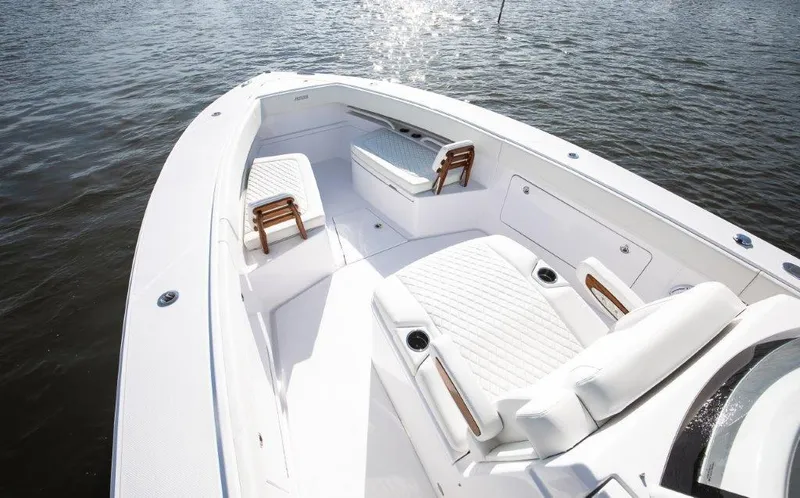  Yacht Photos Pics 2024 Jupiter 340LS boat with white seating and wooden accents on calm water.