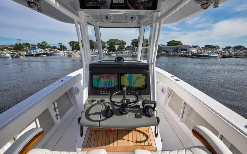  Yacht Photos Pics 2024 Jupiter 340LS boat helm with advanced navigation system, docked in a marina.