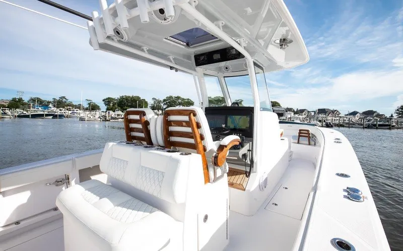  Yacht Photos Pics 2024 Jupiter 340LS boat with luxurious seating and modern helm, docked in a marina.