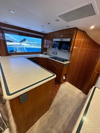  Yacht Photos Pics 2001 Hatteras 60 Convertible yacht kitchen with modern appliances and wood cabinetry.