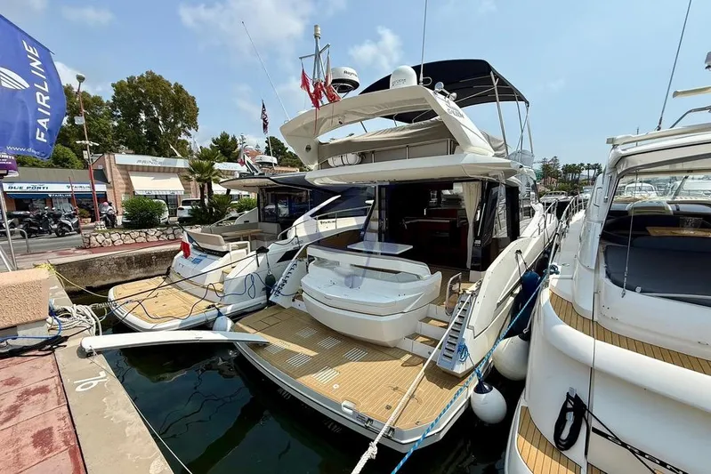  Yacht Photos Pics 2022 Galeon 460 Fly yacht docked at marina, showcasing luxury design and spacious deck.