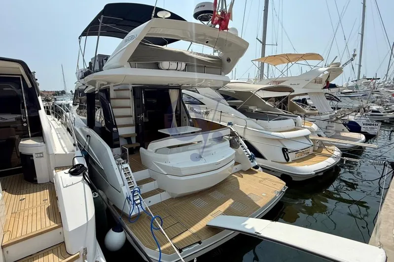  Yacht Photos Pics 2022 Galeon 460 Fly yacht docked at marina, showcasing sleek design and spacious deck.