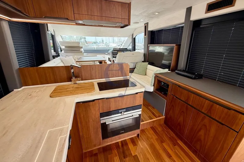  Yacht Photos Pics Luxurious interior of 2022 Galeon 460 Fly yacht with modern kitchen and seating area.