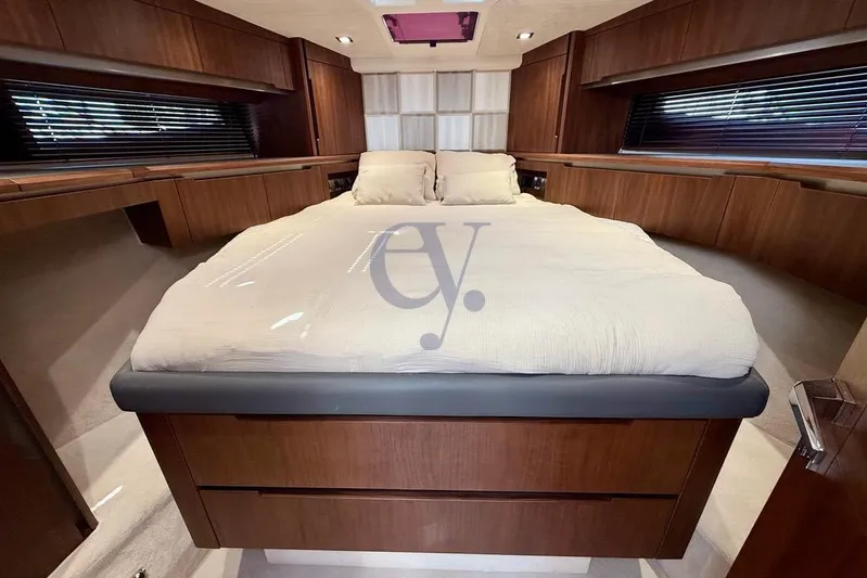  Yacht Photos Pics Luxurious bedroom interior of 2022 Galeon 460 Fly yacht with elegant wood finish.