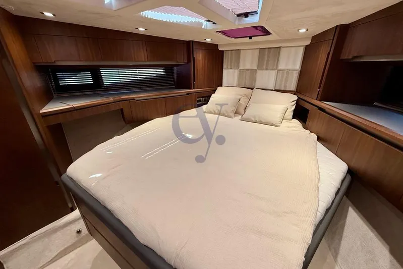  Yacht Photos Pics Luxurious bedroom interior of 2022 Galeon 460 Fly yacht with elegant wood finish.