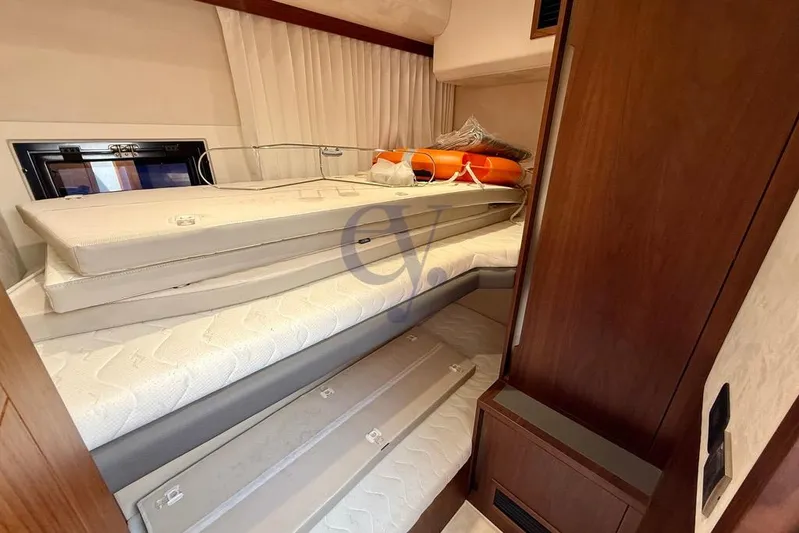  Yacht Photos Pics Interior cabin of 2022 Galeon 460 Fly yacht with stacked mattresses and life preserver.