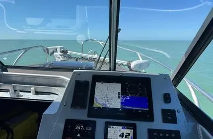  Yacht Photos Pics 2023 Extreme Boats 745 Game King dashboard view with navigation screens, open sea ahead.