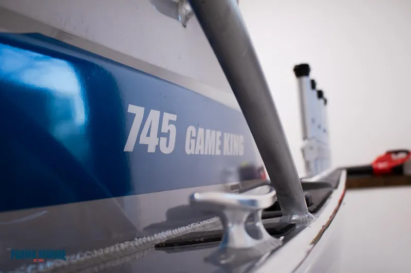  Yacht Photos Pics 2023 Extreme Boats 745 Game King, close-up of boat's side and cleat.