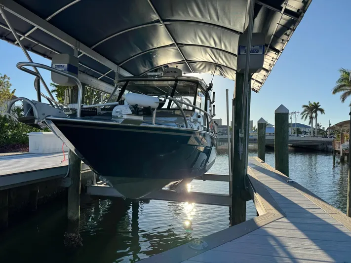  Yacht Photos Pics 2023 Extreme Boats 745 Game King docked under a canopy in a marina.