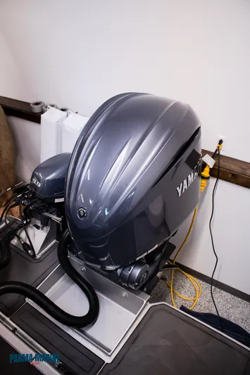  Yacht Photos Pics 2023 Extreme Boats 745 Game King with Yamaha outboard motor in a workshop setting.